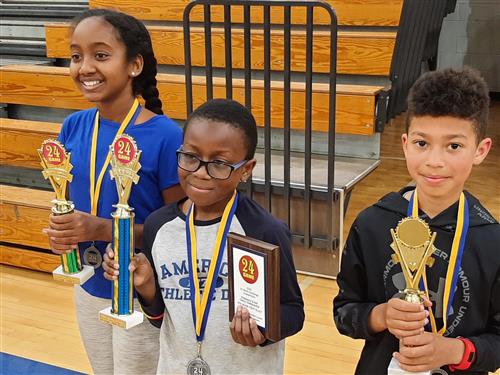 4th Grade 24 Game winners and placers show-off ribbons and trophies in a group picture.